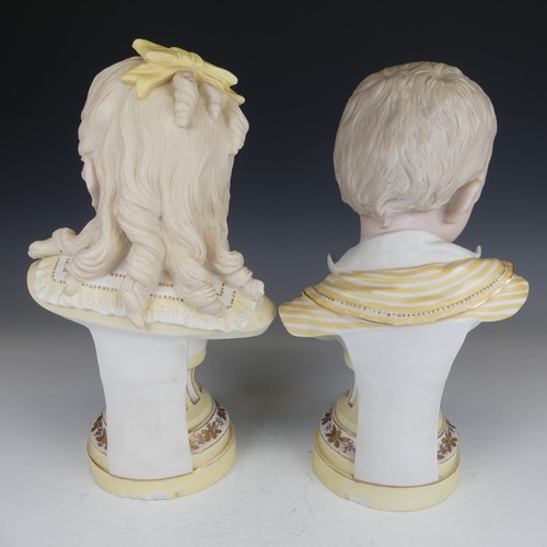 33 - A pair of early 20thC bisque Busts, modelled as a boy and girl, on fluted plinth base, H 29cm (2)... 