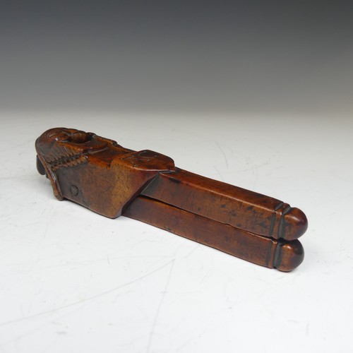 392 - An Early Folk treen Nut Cracker, possibly 17th century, featuring a totem style head in naïve form, ... 