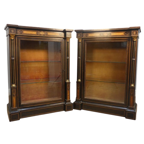 393 - A pair of 19th century gilt mounted ebonised Pier Cabinets, each with an oversailing rectangular top... 