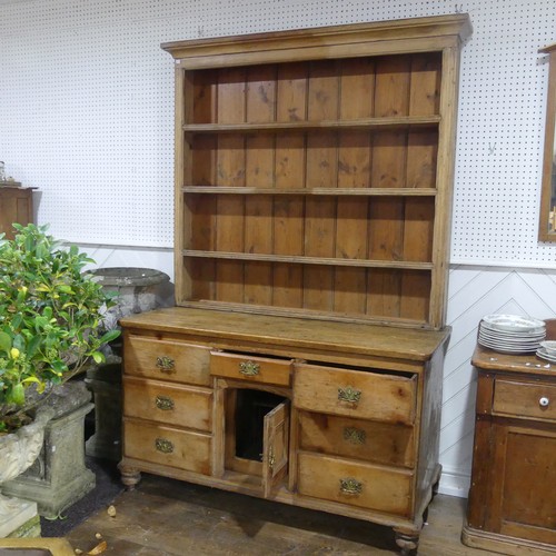 395 - An Antique pine Dresser, moulded cornice above three shelves with hooks, raised on dresser base with... 