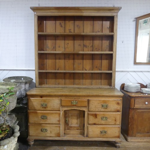 395 - An Antique pine Dresser, moulded cornice above three shelves with hooks, raised on dresser base with... 