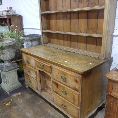 395 - An Antique pine Dresser, moulded cornice above three shelves with hooks, raised on dresser base with... 