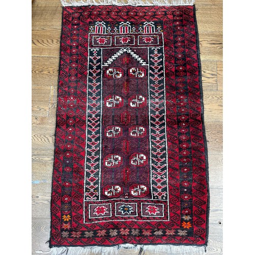 518 - Tribal Rugs; an Afghan red-ground rug, 100% wool, 153cm x 89cm.