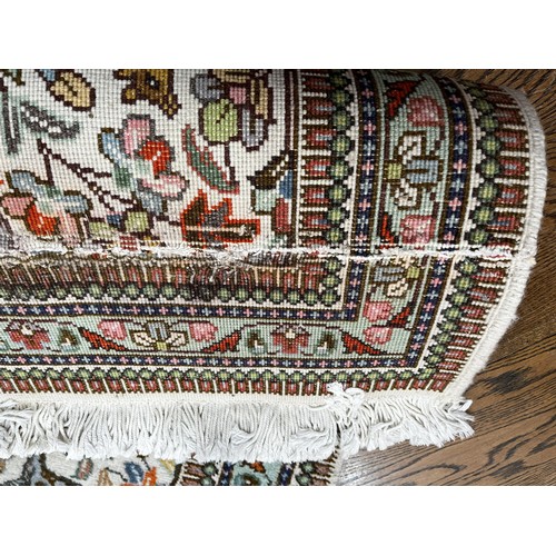 521 - Tribal Rugs; a hand-knotted Persian Tabriz runner, wool pile on cotton base, cream ground woven with... 