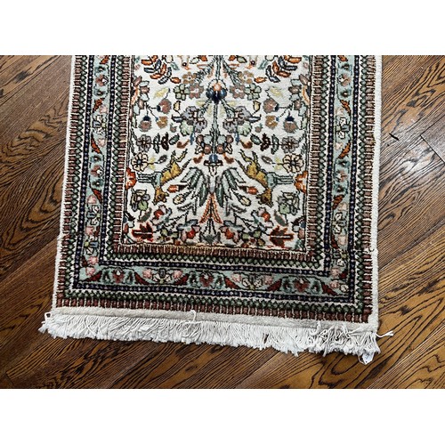 521 - Tribal Rugs; a hand-knotted Persian Tabriz runner, wool pile on cotton base, cream ground woven with... 