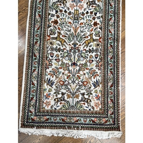 521 - Tribal Rugs; a hand-knotted Persian Tabriz runner, wool pile on cotton base, cream ground woven with... 