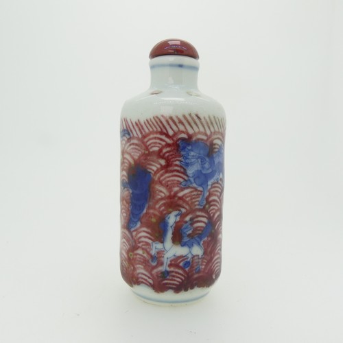 95 - An antique Chinese porcelain Snuff Bottle, depicting figures and animals in underglaze blue with ove... 