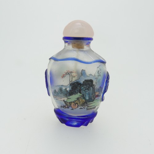 99 - A Chinese interior painted and overlayed glass Snuff Bottle, with interior scene of villagers enclos... 