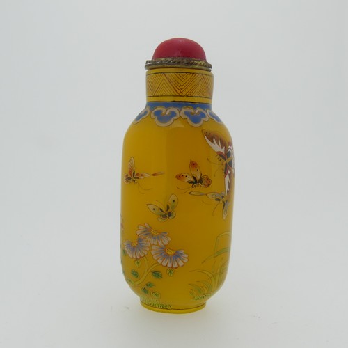 100 - A Chinese glass Snuff Bottle, of yellow ground painted with floral enamels, red stone stopper, three... 