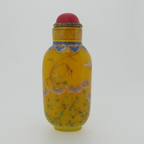 100 - A Chinese glass Snuff Bottle, of yellow ground painted with floral enamels, red stone stopper, three... 