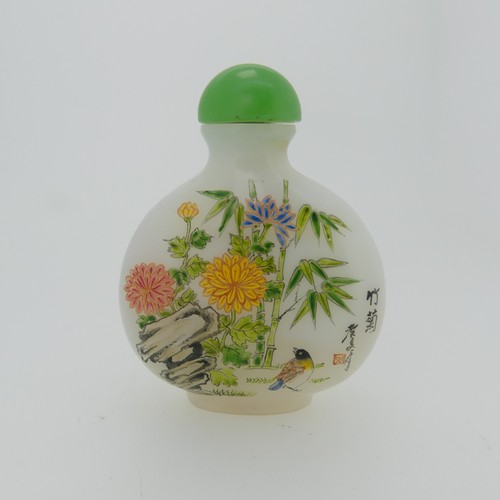 100 - A Chinese glass Snuff Bottle, of yellow ground painted with floral enamels, red stone stopper, three... 