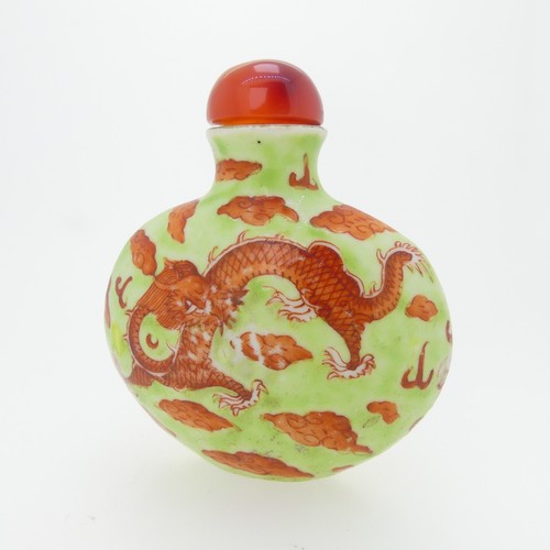 101 - A Chinese porcelain Snuff Bottle, depicting iron red Dragons on green ground, character mark to base... 