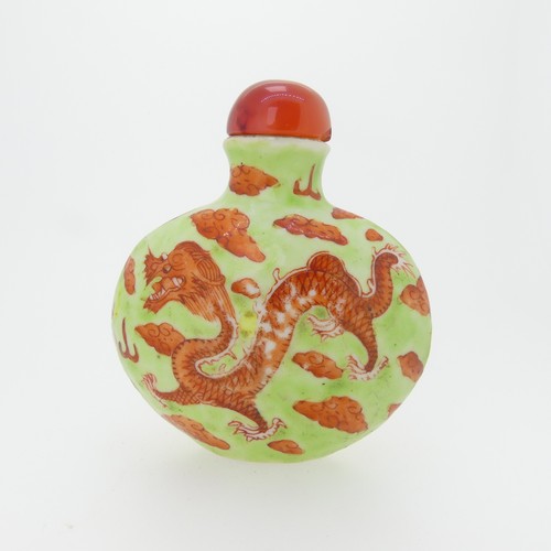 101 - A Chinese porcelain Snuff Bottle, depicting iron red Dragons on green ground, character mark to base... 