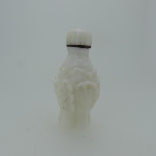 104 - A Chinese rose quartz Snuff Bottle, carved in reflief with flora and fauna, H 9cm, together with an ... 