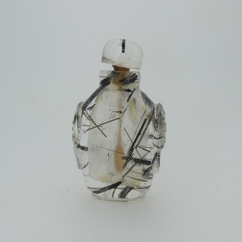 106 - A Chinese rutilated quartz Snuff Bottle and Stopper, of elongated form with relief work heads to sid... 