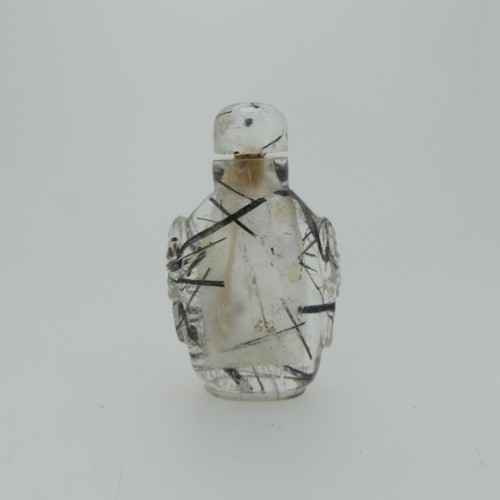 106 - A Chinese rutilated quartz Snuff Bottle and Stopper, of elongated form with relief work heads to sid... 