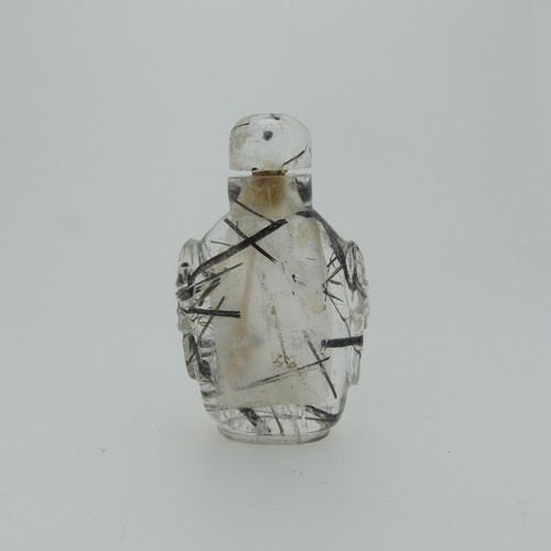 106 - A Chinese rutilated quartz Snuff Bottle and Stopper, of elongated form with relief work heads to sid... 