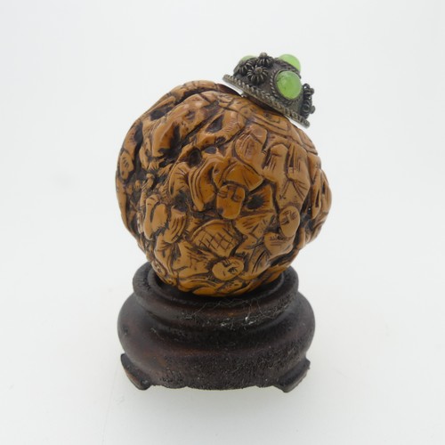 109 - A Chinese 'Luohan' carved walnut shell Snuff Bottle, depicting faces, with metal and stone stopper, ... 