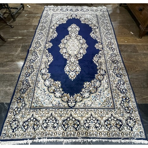 522 - Tribal Rugs; a Persian hand knotted rug, wool pile on cotton base, the royal blue ground with centra... 