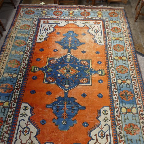 523 - Tribal Rugs; a Turkish hand knotted 100% wool rug, the orange ground woven with bold geometric patte... 