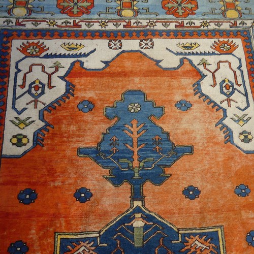 523 - Tribal Rugs; a Turkish hand knotted 100% wool rug, the orange ground woven with bold geometric patte... 