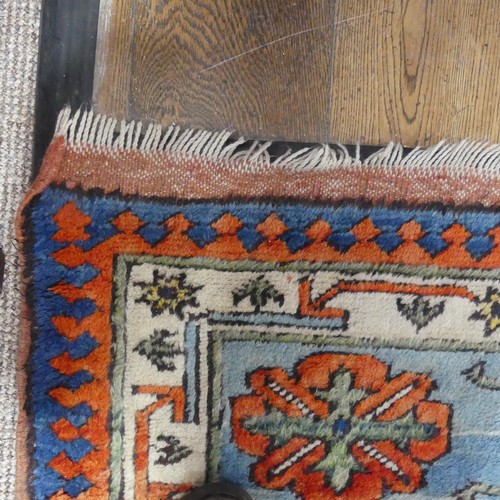 523 - Tribal Rugs; a Turkish hand knotted 100% wool rug, the orange ground woven with bold geometric patte... 