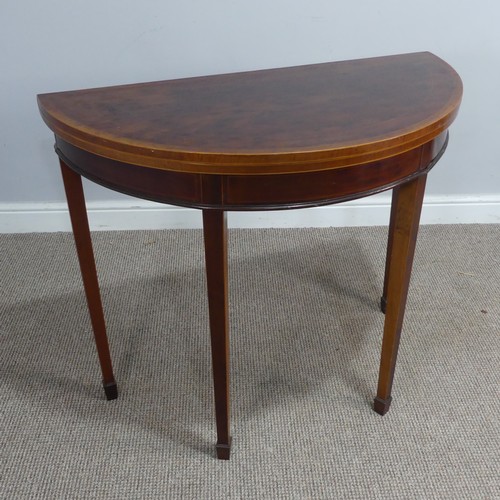 452 - An Edwardian mahogany demi-lune fold-over card Table, chequer inlaid top raised on tapering legs and... 