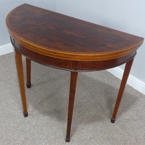 452 - An Edwardian mahogany demi-lune fold-over card Table, chequer inlaid top raised on tapering legs and... 