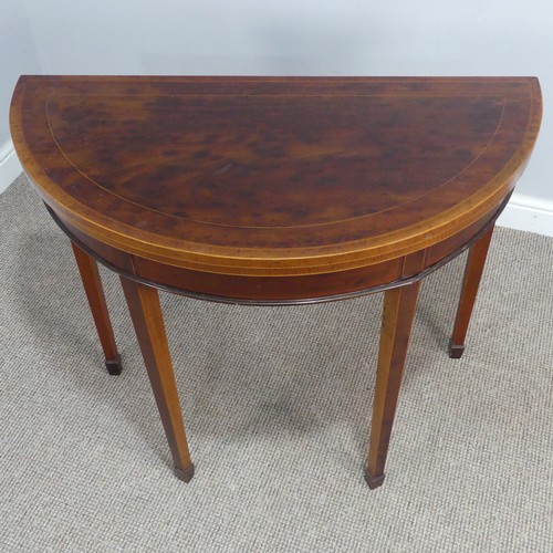 452 - An Edwardian mahogany demi-lune fold-over card Table, chequer inlaid top raised on tapering legs and... 