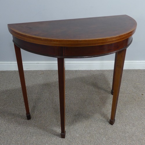 452 - An Edwardian mahogany demi-lune fold-over card Table, chequer inlaid top raised on tapering legs and... 