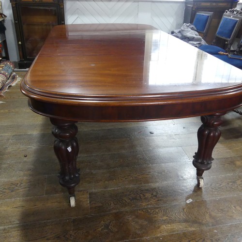 457 - A Victorian mahogany extending Dining Table, raised on bulbous carved legs upon ceramic castors, W 2... 