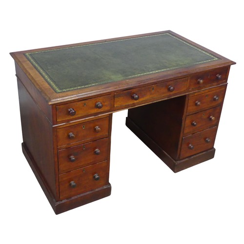 476 - A Victorian mahogany pedestal Desk, with green skived leatherette top, knee hole flanked by three dr... 