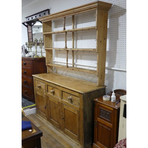 479 - An Antique Pine Kitchen Dresser, moulded cornice over three shelves with hooks, upon base with plint... 