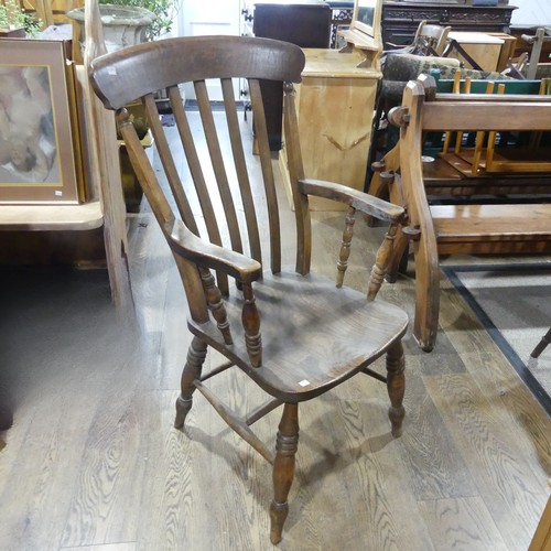 489 - An Edwardian ash and elm Windsor Armchair, with stick and bar back, above moulded shaped saddle seat... 