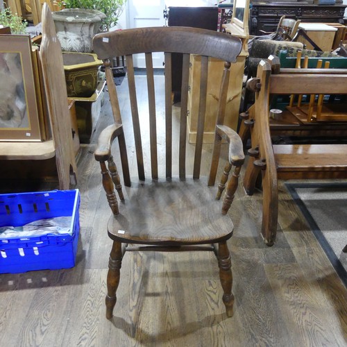 489 - An Edwardian ash and elm Windsor Armchair, with stick and bar back, above moulded shaped saddle seat... 