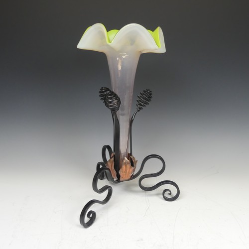 71 - A 20thC glass and wrought iron Epergne, with tripod iron base and copper leaves enclosing trumpet sh... 