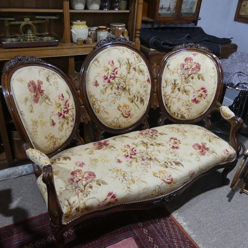 483 - A Victorian walnut Show Frame upholstered Three Seater Sofa, floral carved top, raised on cabriole l... 