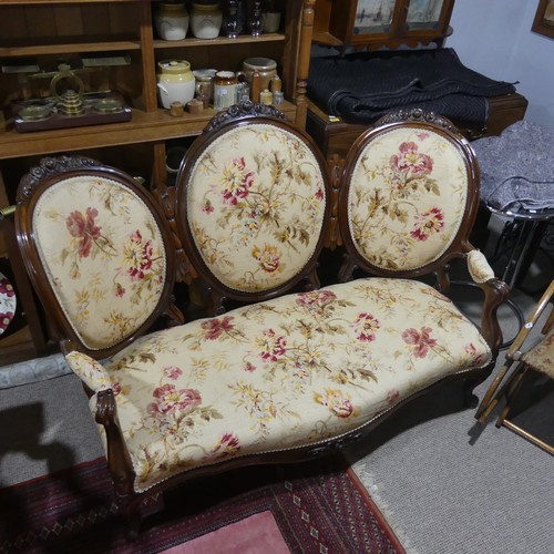 483 - A Victorian walnut Show Frame upholstered Three Seater Sofa, floral carved top, raised on cabriole l... 