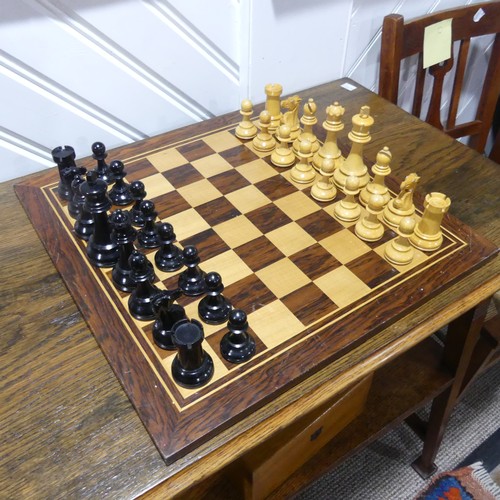 512 - A Staunton pattern boxwood and ebony Chess Set, the knights with glass eyes, kings 10.5 cm, with box... 