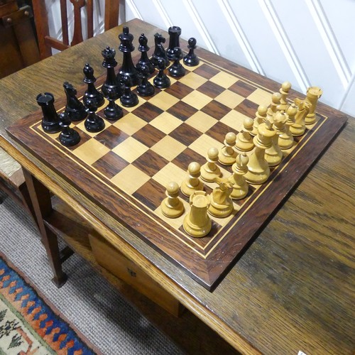 512 - A Staunton pattern boxwood and ebony Chess Set, the knights with glass eyes, kings 10.5 cm, with box... 