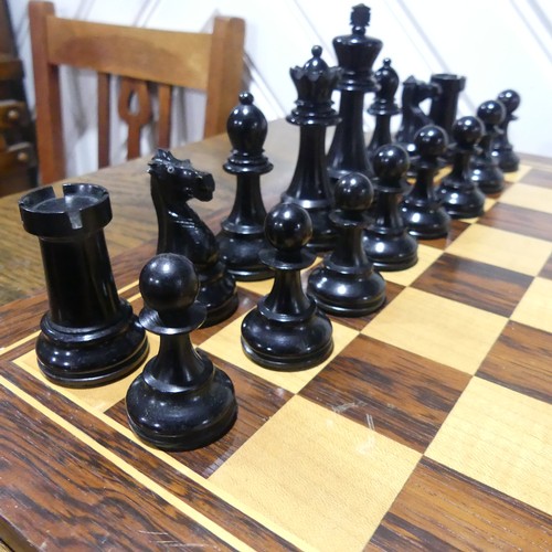 512 - A Staunton pattern boxwood and ebony Chess Set, the knights with glass eyes, kings 10.5 cm, with box... 