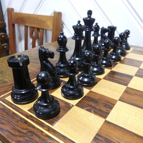 512 - A Staunton pattern boxwood and ebony Chess Set, the knights with glass eyes, kings 10.5 cm, with box... 