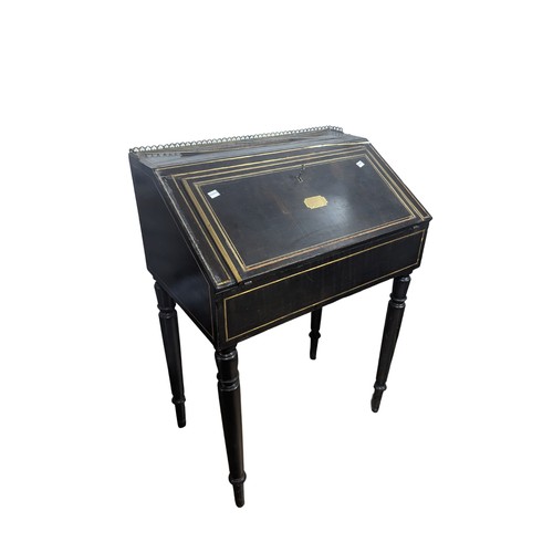 437 - A Victorian ebonised lady’s writing Desk, with brass strip inlay, gothic style gallery above sloped ... 