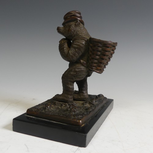 124 - A novelty Vesta holder in the form of a gilt bronze Bear, with a top hat and a basket on his back, r... 