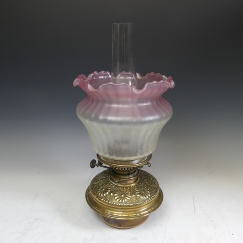 416 - A 19thC oil Lamp, with Art Nouveau style shade, Everard and Co burner, glass font with embossed bras... 