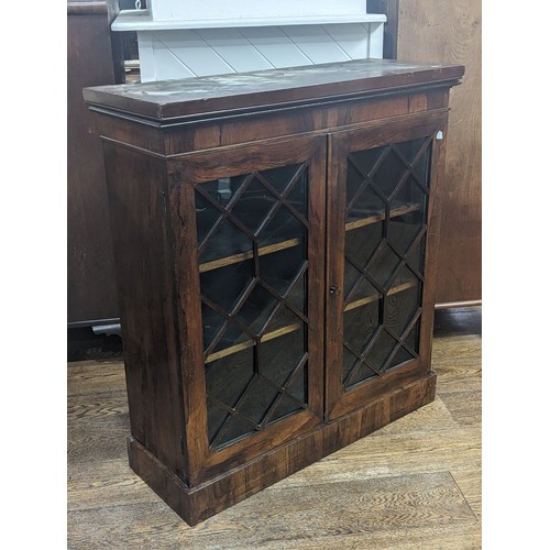 451 - A Victorian rosewood astragal glazed Bookcase, moulded cornice above two shelves, raise on plinth ba... 