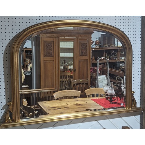 417 - A giltwood arched framed overmantle Mirror, with bevelled mirror plate, W 124.5 cm x H 78.5 cm.... 