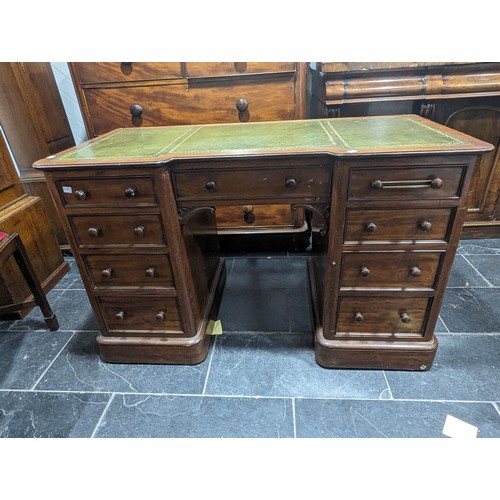 488 - An Edwardian mahogany Inverted Breakfront Desk, green tooled leather writing surface, above three sh... 