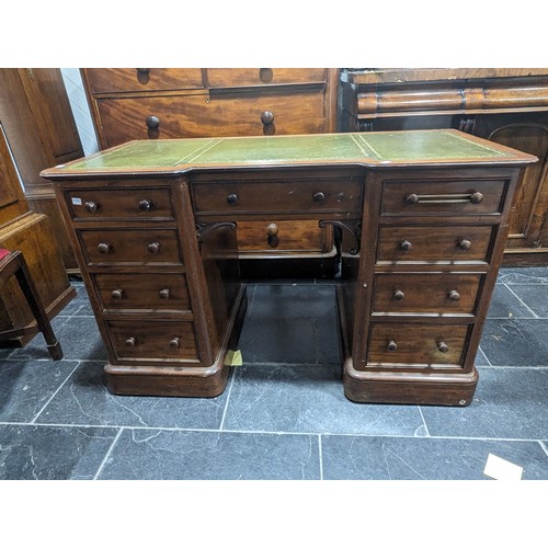 488 - An Edwardian mahogany Inverted Breakfront Desk, green tooled leather writing surface, above three sh... 