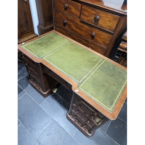 488 - An Edwardian mahogany Inverted Breakfront Desk, green tooled leather writing surface, above three sh... 